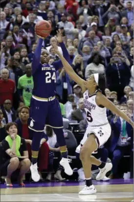  ?? RON SCHWANE — THE ASSOCIATED PRESS ?? Notre Dame’s Arike Ogunbowale sinks a 3-point basket over Mississipp­i State’s Victoria Vivians, right, to win the NCAA title on April 1 in Columbus.