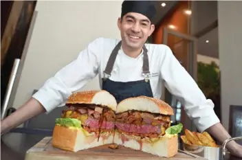  ??  ?? Patrick Shimada, the chef de cuisine at The Oak Door of the Grand Hyatt Tokyo hotel poses with a 3kg burger in Tokyo. — AFP photo