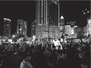  ?? Associated Press ?? ■ Protesters stand in unity in Romare Bearden Park as they prepare to march throughout the city of Charlotte, N.C.