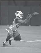  ?? ROB SCHUMACHER/AZCENTRAL SPORTS ?? Cardinals rookie safety Budda Baker reaches for the ball during the opening day of training camp on July 22 in Glendale.