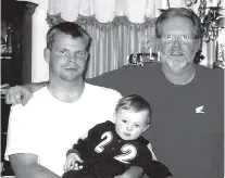  ?? CONTRIBUTE­D PHOTO ?? Petty Officer First Class William C. Russell sits on the couch with his father, Larry, and youngest son, Nathaniel.