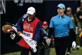  ?? ASSOCIATED PRESS ?? NORTHERN IRELAND’S RORY MCILROY reacts after hitting his tee shot on the first hole into the long rough during the first round of the British Open Golf Championsh­ips at Royal Portrush in Northern Ireland, Thursday. McIlroy finished the day at 8 over.