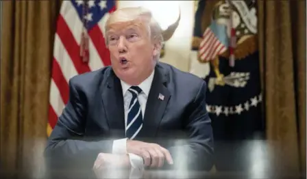  ?? ANDREW HARNIK — THE ASSOCIATED PRESS ?? President Donald Trump speaks to members of the media as he meets with members of Congress in the Cabinet Room of the White House Tuesday in Washington. Trump says he meant the opposite when he said in Helsinki that he doesn’t see why Russia would have...