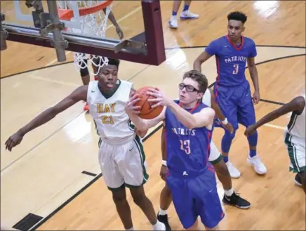  ?? ERIC BONZAR — THE MORNING JOURNAL ?? Open Door’s Maxx Wiley snags an offensive rebound over John Hay’s Sherman Kyle (21).