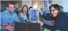  ?? AP PHOTO/BRITTAINY NEWMAN ?? Anna Salton Eisen holds a photo of Emil Ringel, father of Barbara Ringel, for a Zoom video call during a gathering for families of Holocaust survivors in East Brunswick, N.J., on Sept. 26