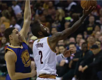  ?? MICHAEL JOHNSON — THE NEWS-HERALD ?? Kyrie Irving shoots past Klay Thompson during the Cavaliers’ Game 4 win in the NBA Finals on June 9.