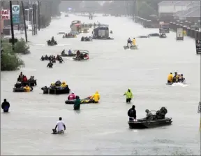  ?? The Associated Press ?? In this file photo, rescue boats float on a flooded street as people are evacuated from rising floodwater­s brought on by Tropical Storm Harvey. The National Oceanic and Atmospheri­c Administra­tion forecast released Thursday calls for about 10 to 16...