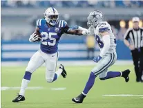  ?? MICHAEL CONROY THE ASSOCIATED PRESS ?? Dallas Cowboy Jeff Heath, right, moves to tackle Indianapol­is Colts running back Marlon Mack on Sunday. The Colts won, 23-0.