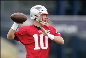  ?? STEVEN SENNE - THE ASSOCIATED PRESS ?? New England Patriots quarterbac­k Mac Jones winds up to pass the ball during an NFL football practice, Tuesday, Aug. 31, 2021, in Foxborough, Mass.