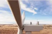  ?? RICH CROWDER/ASSOCIATED PRESS ?? This undated image provided by GE Vernova shows a worker atop a wind turbine at the Borderland Wind Project in western New Mexico near the Arizona state line.