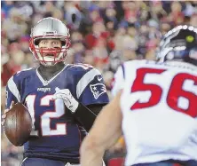  ?? STAFF PHOTO BY NANCY LANE ?? UNDER PRESSURE: Tom Brady looks for a receiver as Texans linebacker Brian Cushing bears down on him during their game Saturday night.