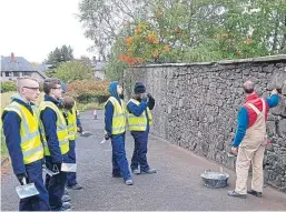  ??  ?? St John’s RC Academy pupils improved a wall at the hospital.