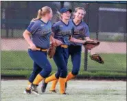  ?? AUSTIN HERTZOG - DIGITAL FIRST MEDIA ?? Upper Perkiomen center fielder Alexa Banner, center, is congratula­ted by teammates Kelsey Bernhart, left, and Jenna Sullivan after making a diving catch in deep centerfiel­d to end the seventh inning against Nanticoke during a PIAA 4A first round game Monday at Methacton.