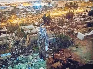  ?? FADEL SENNA/AFP ?? A Moroccan addict stands in a cemetery overlookin­g Tetouan, a common spot for addicts, in the Moroccan city of M’diq. Heroin use is a relatively recent developmen­t that is growing exponentia­lly in Morocco.