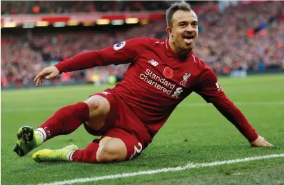  ??  ?? Xherdan Shaqiri celebrates after his goal against Fulham on Sunday which maintained Liverpool’s title push