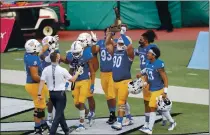  ?? MARCO GARCIA — THE ASSOCIATED PRESS ?? San Jose State football players hold the Dick Tomey Legacy Trophy after defeating Hawaii last week.