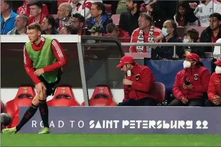  ?? The Associated Press ?? Ajax’s Perr Schuurs warms up next to a Road to Saint Petersburg 22 banner, referring to the Champions League host city, during a match against Benfica in Lisbon, Portugal, on Wednesday. UEFA on Friday moved the soccer final to Paris after the Russian invasion of Ukraine.