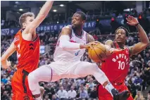  ?? MARK BLINCH/THE CANADIAN PRESS ?? Miami Heat guard Dwyane Wade was part of a strong Miami heat second unit that gave Jakob Poeltl, left, DeMar DeRozan and the rest of the Toronto Raptors fits Tuesday in Toronto.