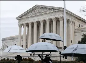  ?? (Bloomberg News WPNS/Eric Lee) ?? Members of the media set up equipment and umbrellas outside the U.S. Supreme Court in Washington on Wednesday.
