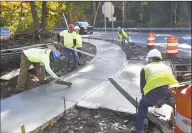  ??  ?? Workers from Grasso Companies of Norwalk construct a sidewalk at the intersecti­on of Pulaski Highway and Prindle Avenue in Ansonia.