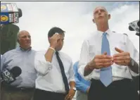  ?? The Associated Press ?? WATER WARS: In this Aug. 13, 2013 photo, Rep. Steve Southerlan­d, R-Fla. and Sen. Marco Rubio listen to Florida Gov. Rick Scott announce a lawsuit against the state of Georgia, while touring Apalachico­la, Fla. Florida is hoping the Supreme Court will...