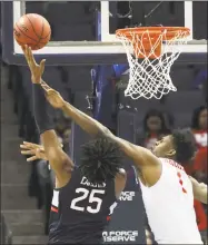  ?? Troy Glasgow / Associated Press ?? Houston’s Chris Harris Jr., right, defends as UConn’s Josh Carlton shoots during the AAC quarterfin­als.