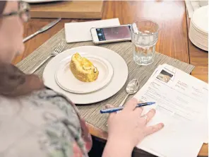  ??  ?? RIGHT Nichole Aksamit, a senior editor for Allrecipes, tests a baked omelet roll.