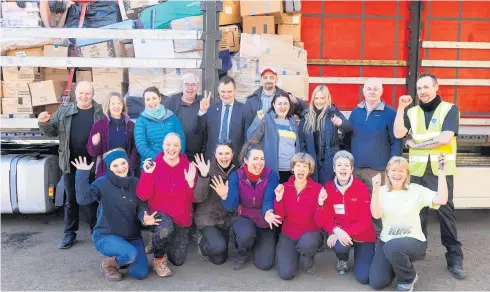  ?? ?? Aid effort Lukasz Lutostansk­i, the Consul General for Poland, with volunteers at the Errol warehouse