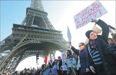  ?? JACKY NAEGELEN / REUTERS ?? Protesters take part in the Women’s March in Paris, France, on Saturday. The march formed part of a worldwide day of action following the inaugurati­on of Donald Trump as US President.