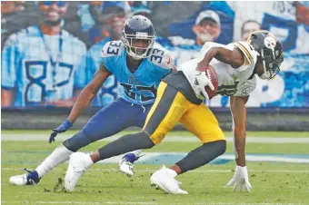  ?? AP PHOTO/ WADE PAYNE ?? Pittsburgh Steelers wide receiver Diontae Johnson, right, gets past Tennessee Titans cornerback Johnathan Joseph to score a touchdown on Oct. 25 in Nashville. The Titans waived Joseph on Monday, one of a series of moves made to retool the defense with the regular season almost halfway over and their struggles on that side of the ball mounting.