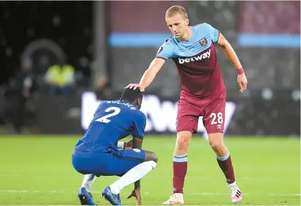  ?? AFP-Yonhap ?? West Ham United’s Czech midfielder Tomas Soucek, right, consoles Chelsea’s German defender Antonio Rudiger after the English Premier League football match between West Ham United and Chelsea at the London Stadium, in east London, Wednesday.