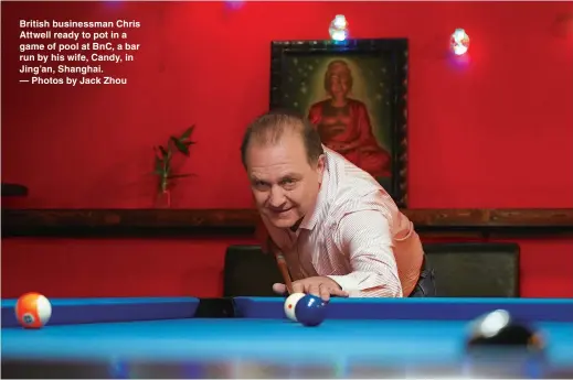  ??  ?? British businessma­n Chris Attwell ready to pot in a game of pool at BnC, a bar run by his wife, Candy, in Jing’an, Shanghai. — Photos by Jack Zhou