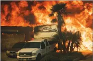  ?? AP PHOTO BY NOAH BERGER ?? Flames consume a home on Via Arroyo as a wildfire rages in Ventura, on Tuesday.