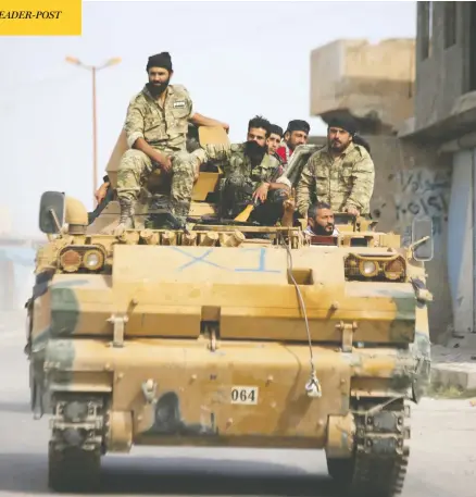  ?? BAKR ALKASEM/AFP VIA GETTY IMAGES ?? Turkish-backed Syrian fighters are seen in Ayn al-arus, Syria, on Monday as Turkey attacks Kurdish-held border towns in the northeast.