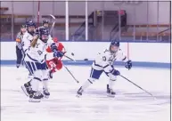  ?? Steve Musco / Yale Athletics ?? Yale defenseman Vita Poniatovsk­aia (21) dumps the puck in ahead of her teammate Grace Lee (13).