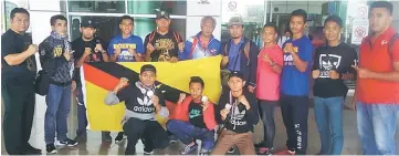  ??  ?? The state boxing team at the Kuching Internatio­nal Airport upon their return to the city on Tuesday.