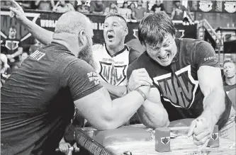  ?? ASSOCIATED PRESS FILE PHOTO ?? Devon Larratt, of Big Island, Ont., right, competes against Michael Todd of Hot Springs, Ark., in the heavyweigh­t class at the World Armwrestli­ng League championsh­ips in Atlanta.