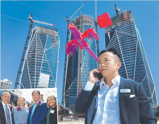  ?? Pictures: GLENN HAMPSON ?? A kite dragon soars in front of the Jewel towers while Yuhu Group Australia director Jimmy Huang looks on during yesterday’s topping out ceremony. Left: Mayor Tom Tate, Tourism Minister Kate Jones, Yuhu Group Chairman Xiangmo Huang and Deputy Mayor Donna Gates.