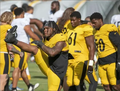  ?? Emily Matthews/Post-Gazette ?? Steelers linebacker Buddy Johnson stretches with his teammates during practice Friday at Heinz Field.