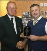  ??  ?? Denis Hennessy, Chairman of the Wexford Football League presents Ken O’Neill, club chairman, with an award to mark the 50th anniversar­y.