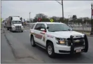  ?? PHOTO PROVIDED ?? A Clinton County patrol vehicle leads the way for a Dunkin’ tractor-trailer filled with thousands of toys Sunday during the Capital Region Toys for Tots Northern New York Sheriffs Coalition Road Train, powered by Dunkin’ and Upstate Transit of Saratoga.