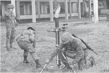  ??  ?? Philippine Marines prepare to fire mortars at Muslim militant positions at the front line in Marawi, on the southern island of Mindanao, July 22. The Philippine Congress voted the same day to extend martial law in the south until the end of the year.