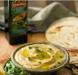  ??  ?? Hummus, a popular Mediterran­ean appetizer that uses olive oil, which delivers a pleasant aroma and enhances the flavor
