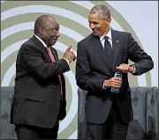  ?? AP/THEMBA HADEBE ?? South African President Cyril Ramaphosa (left) and former U.S. President Barack Obama share a lightheart­ed moment Tuesday during a Johannesbu­rg event where Obama denounced “politics of fear, resentment, retrenchme­nt,” urging the preservati­on of values that he said are under threat.