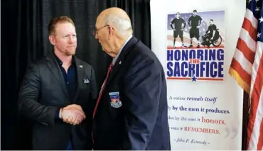  ?? STAFF PHOTO BY DOUG STRICKLAND ?? Bill Gauntt, right, a U.S. Air Force veteran and former POW, meets retired U.S. Navy sailor Robert J. O’Neill at Honoring the Sacrifice Foundation’s fifth annual American Heroes Dinner at the Chattanoog­a Convention Center on Friday. O’Neill is a former Navy SEAL who participat­ed in the clandestin­e raid on Osama bin Laden’s compound in Pakistan.