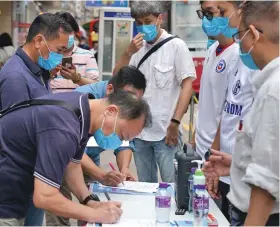  ??  ?? Residents sign in a street campaign in support of national security legislatio­n for Hong Kong Special Administra­tive Region in Hong Kong, China, on May 23, 2020.