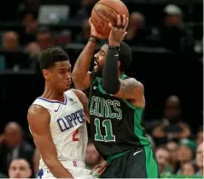  ?? STUART CAHILL / BOSTON HERALD ?? STUCK: Kyrie Irving looks for room to maneuver against Shai Gilgeous-Alexander.