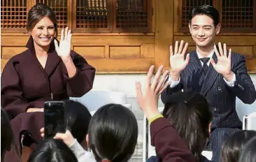  ??  ?? Reaching out to youths: US First Lady Melania Trump and Choi Min-ho, a member of South Korean boy band Shinee, waving at South Korean middle school students during the Girls Play 2! Initiative, an Olympic public diplomacy outreach campaign, at the US Ambassador’s Residence in Seoul. — AFP