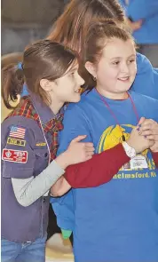  ?? STAFF PHOTOS BY PATRICK WHITTEMORE ?? MAKING HER-STORY: Hazel Leatherman, left, and Kiara Gingras, above and right with Samantha Richards, cheer at yesterday’s Pinewood Derby. Below, Hazel, Kiara and Samantha, join Leah Downs, front, and Charlie Henderson.