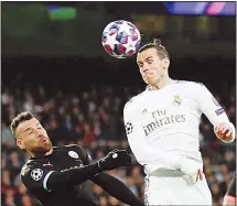  ??  ?? Real Madrid’s Gareth Bale (right), jumps for the ball with Manchester City’s Nicolas Otamendi during the Champions League, Round of 16, first leg soccer match between Real Madrid and Manchester City at the Santiago
Bernabeu stadium in Madrid, Spain on Feb 26. (AP)